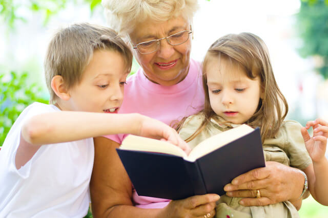 Grandmother reading to her grandchildren